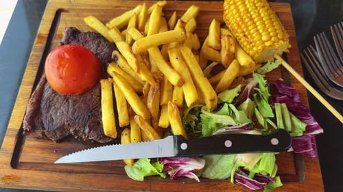 Steak steakhouse beef dinner meal, expensive restaurant, corn salad fries