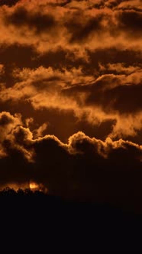 Sun Rises Through Clouds in a Time Lapse
