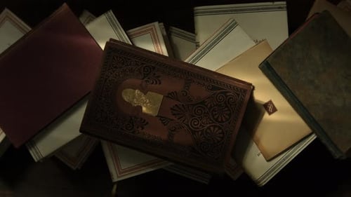 Top View of a Stack of Old Books Lying on a Wooden Table