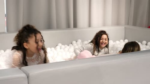 Two Funny Girls are Playing in the Dry Pool at the Entertainment Center