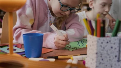 Children Drawing Together at Table at Home