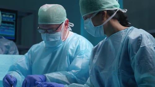 Team of Professional Medical Surgeons Performs the Surgical Operation in a Modern Hospital Doctors