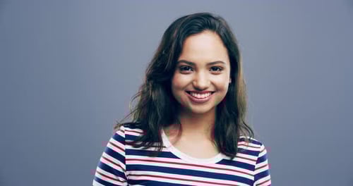 Smiling Woman Making Heart Shape with Hands