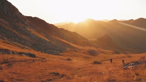 Golden Hour Mountain Walkers at Scenic Sunset