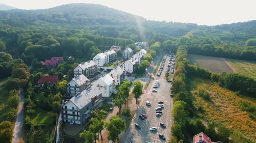 Modern Residential Houses Surrounded By Forest and Mountains Aerial View
