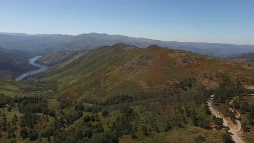 Cinematic Drone View of Winding River Through Lush Green Valley
