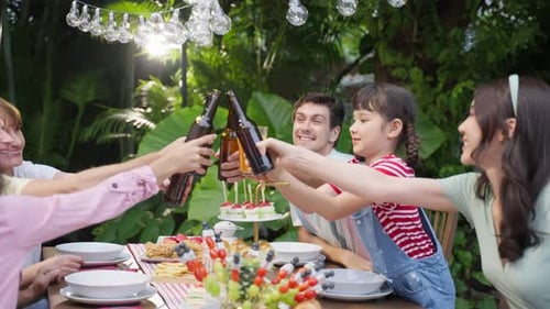 Multi-ethnic big family having fun, enjoy party outdoors in the garden.