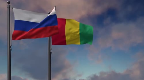 Russia and Guinea Flags Waving Together on Flagpoles