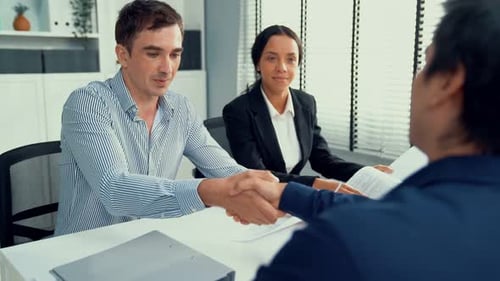 Business Agreement with Handshake in Modern Office