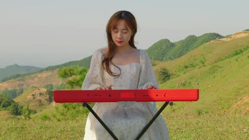 Woman Plays Keyboard in Rural Meadow Setting