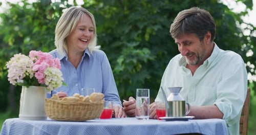Couple Enjoying a Meal and Conversation in Garden