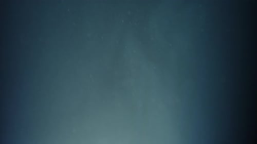 Abstract blue background with particles floating in motion