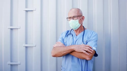 Doctor with Face Mask and Arms Crossed