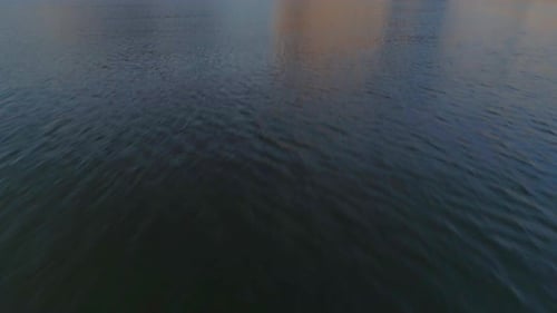 AERIAL - Drone Tilt Up Over Desert Lake to Reveal Mountain (Canyon Lake)