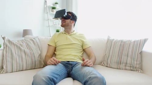 Man experiences virtual reality on the sofa