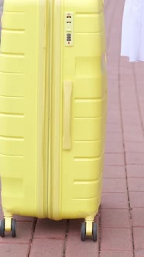 Bright Yellow Suitcase Waiting for Train Travel