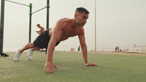 Muscular Man Doing Push-Ups Outdoors