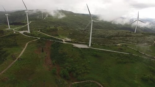 Aerial View of Wind Turbines or Windmills Farm Field in Industry Factory with Fog
