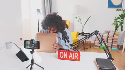 Young Adult Unboxing Tech for Live Stream