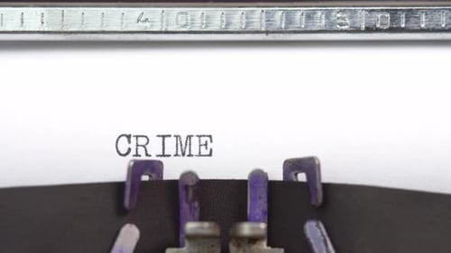Crime word close up being typing and centered on a sheet of paper on old vintage typewriter mech