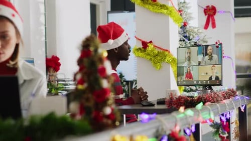 Employee Videocalls Team in Xmas Office