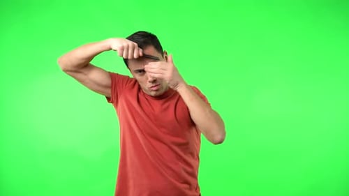 Adult Combs Hair and Reacts on Green Screen