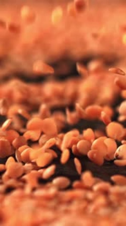 Red Lentils Fall on the Table Filmed on a Highspeed Camera at 1000 Fps