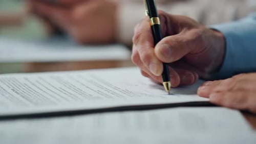 Businessman Hand Signing Agreement Negotiation Table