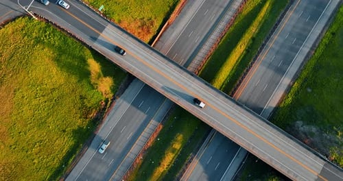 Autoestrada acima de duas rodovias no campo. Vista superior das estradas com carros em movimento