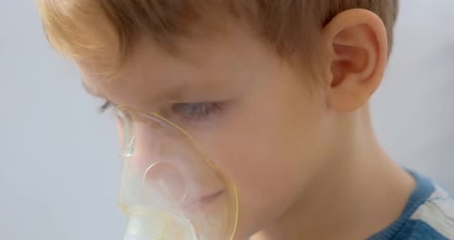 Young Boy Uses Nebulizer Mask for Treatment