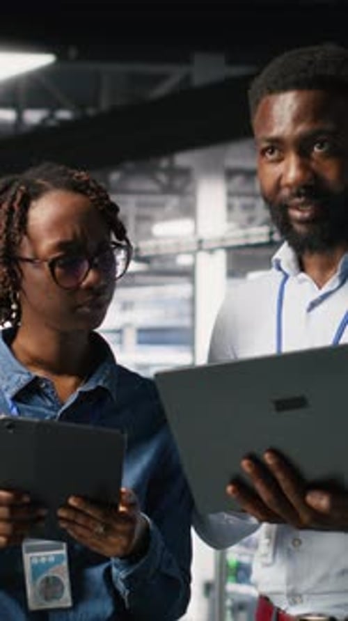 Vertical Video Data Center Admins Running Diagnostics on Equipment Doing Brainstorming
