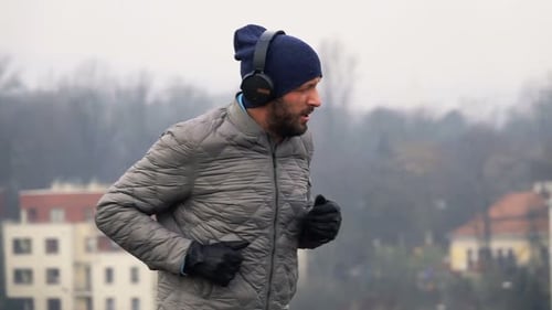 Male Jogger in Headphones Running in City Park, Super 240