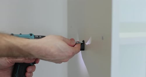 Man Using Power Drill Indoors for Home Improvement
