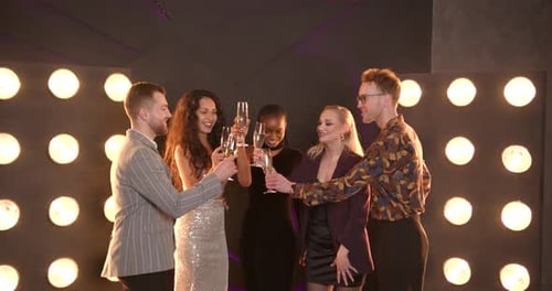 Friends Toasting with Champagne as Confetti Falls