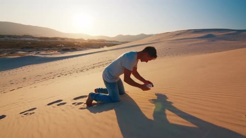 Tired lonely man struggles in the desert with empty bottle of water