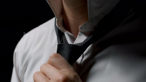 Businessman Adjusting His Tie Knot