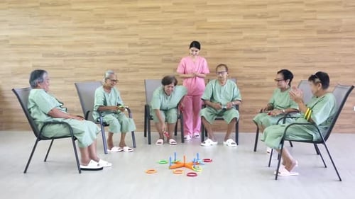Senior Woman With Her Caregiver At Homecare.