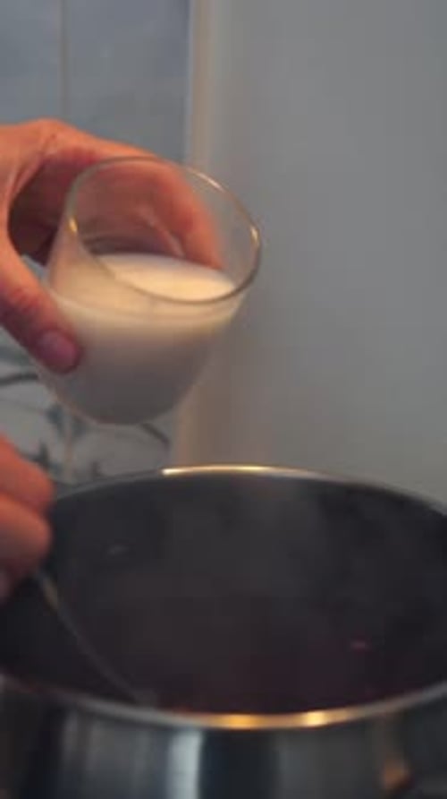 Adding Liquid into Pot while Stirring Food