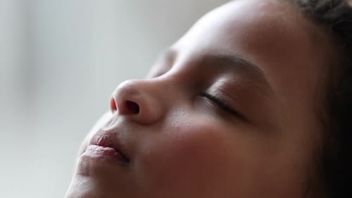 Child Relaxing with Eyes Closed in Portrait Close-up