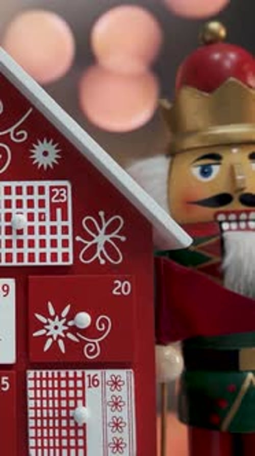 Wooden Tree Advent Calendar in Front of a Real Christmas Tree Decorated Nutcracker Soldier Toys