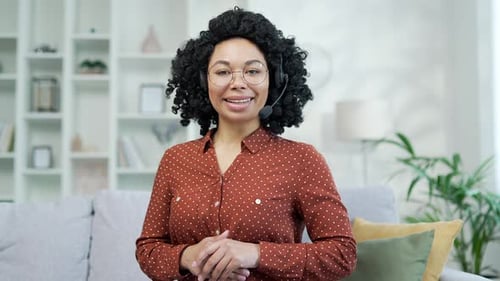 Webcam view. Confident african american businesswoman in headset talking on video call while sitting