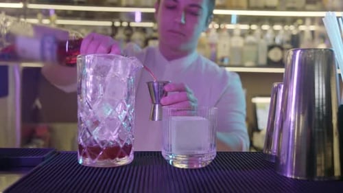 Man Pouring Drink for Cocktail in Bar