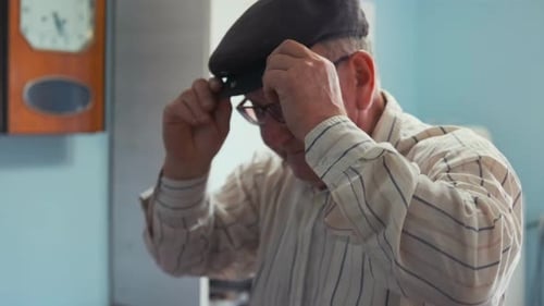 Senior Man Gets Dressed in Home Interior