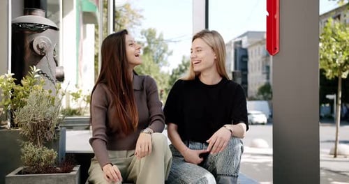 Happy Young Ladies Chatting and Smiling on Street