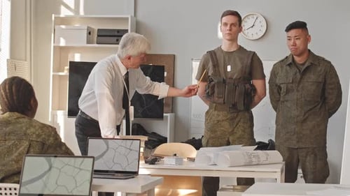Professor Showing Military Equipment to Officers at Military Academy