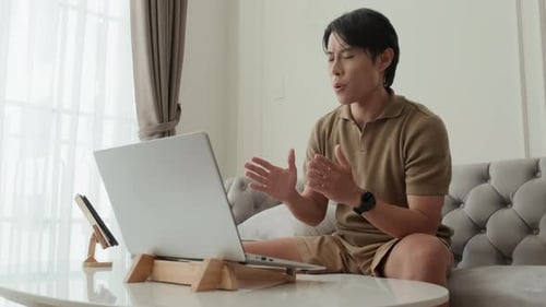 Young Male Home Office Worker Communicating to Colleague in Video Chat