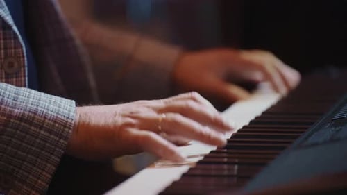 Person playing Piano Keyboard Close Up