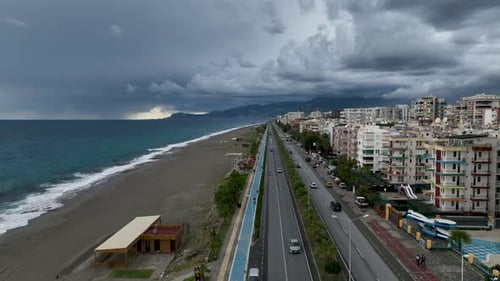 Cars Drives Coastal Road Leading Along the Rocky Beach and the Calm Sea