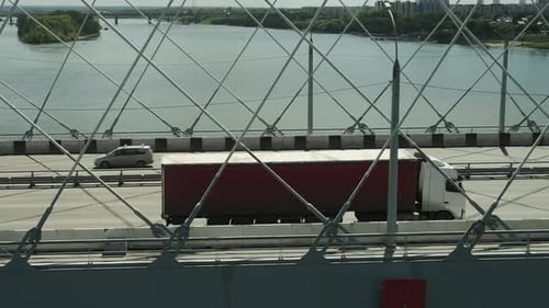 Truck Driving Over a Bridge on a Sunny Day
