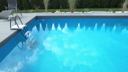 Pool Safety Cover Rolled Up by the Pool Deck
